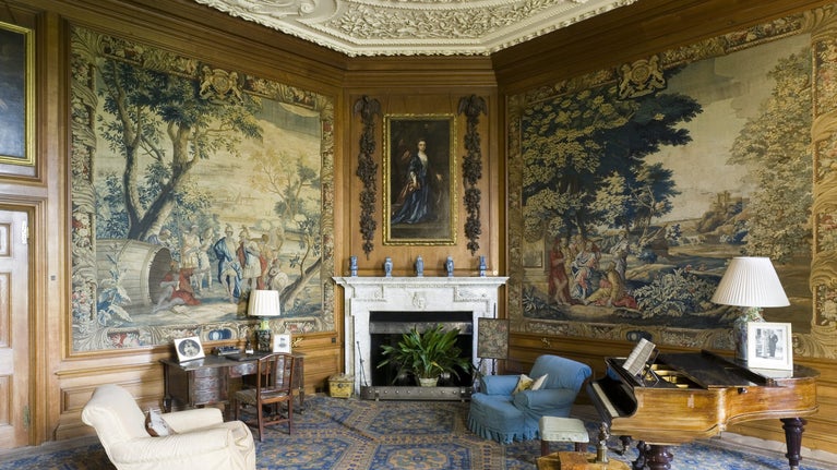 The Tapestry Room at Belton House, Lincolnshire, UK, looking towards the original Wyatville fireplace of 1811-12. The room was remodelled c.1890 in a seventeenth-century style. The tapestries are early C18th from the Mortlake factory and depict scenes from the story of Diogenes.